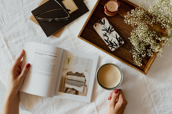 ホットドリンクを飲みながら読書をする人